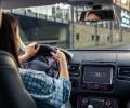 Women driving along empty city road